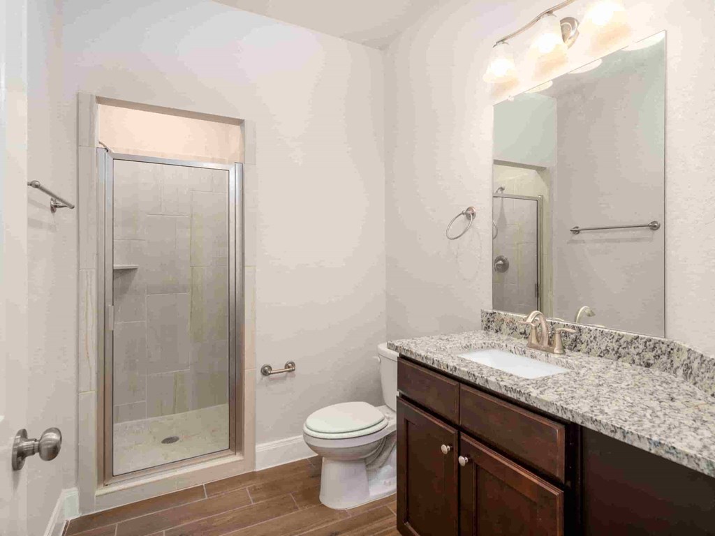 a bathroom with a sink toilet and shower