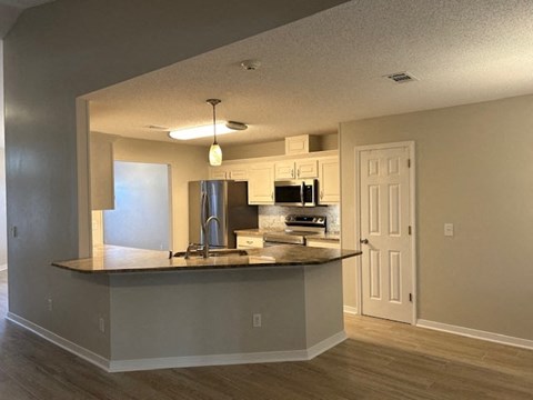 a kitchen with a counter top and a refrigerator