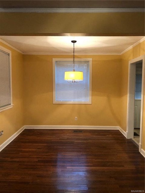 a empty room with yellow walls and a window
