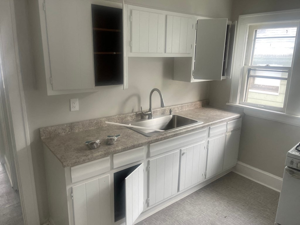 A kitchen with a sink and cabinets.