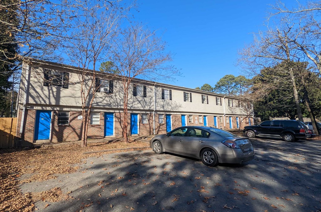 an old building with a car parked in front of it