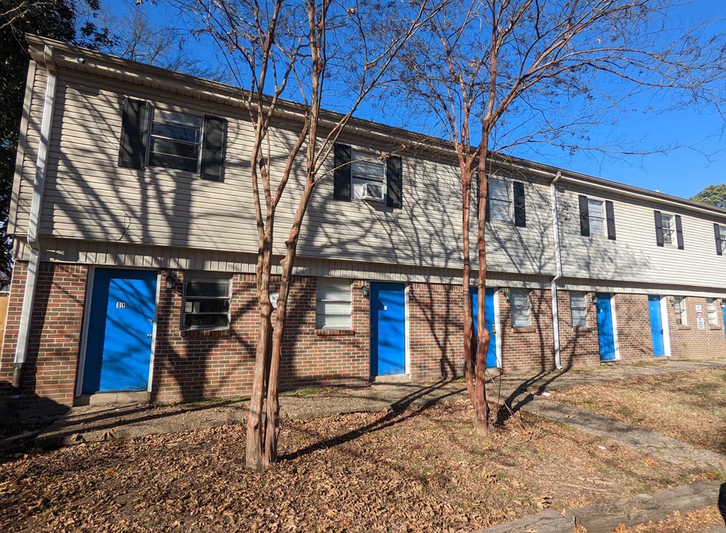 an old building with blue doors and windows