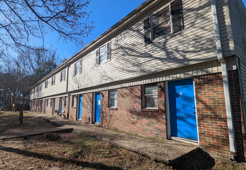 an old brick building with blue doors and windows
