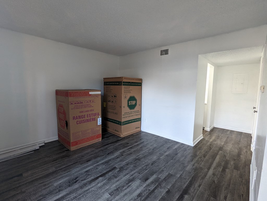 an empty room with boxes in the corner of a room