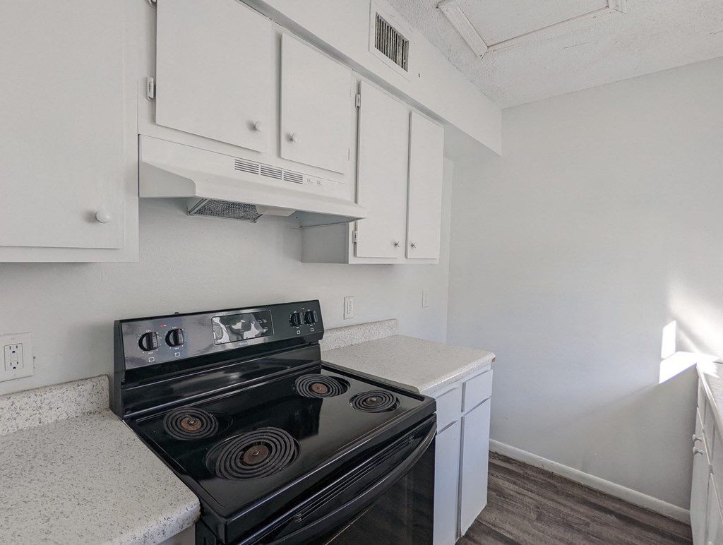 the preserve at ballantyne commons apartment kitchen with stove and white cabinets