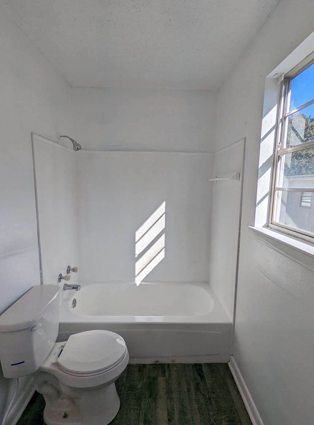 an empty bathroom with a toilet and a bath tub