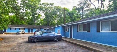 a car parked in front of a blue building
