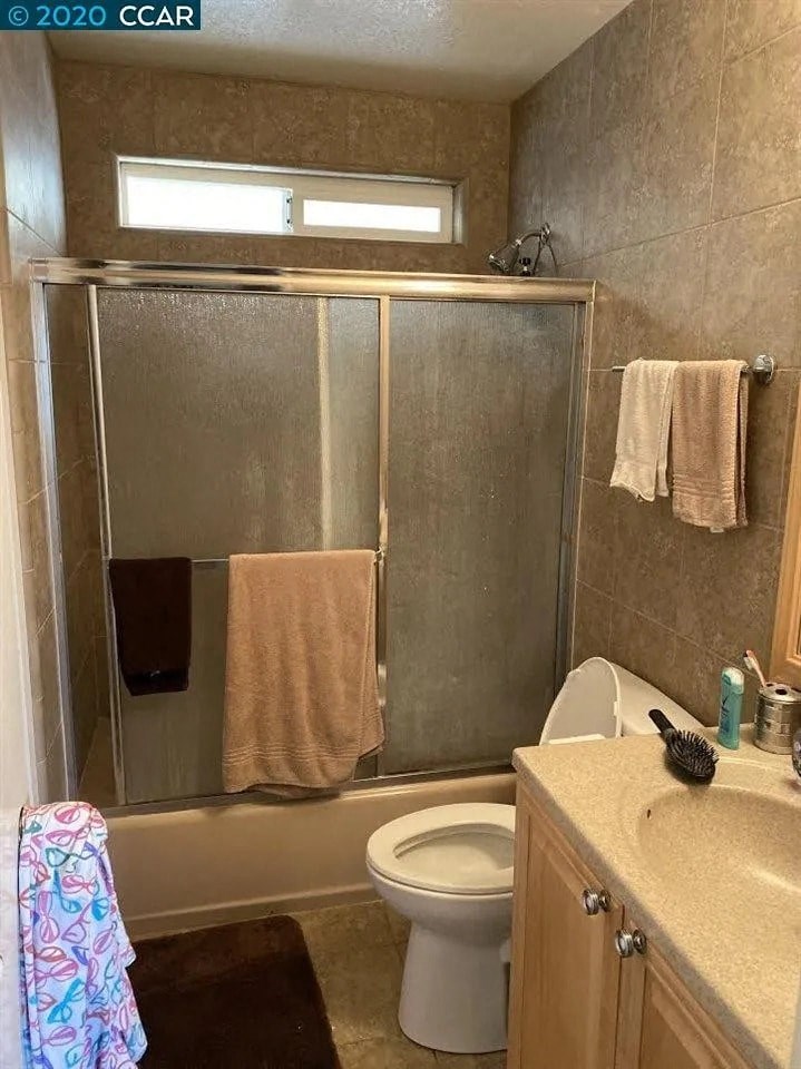 a bathroom with a toilet and a shower and a sink
