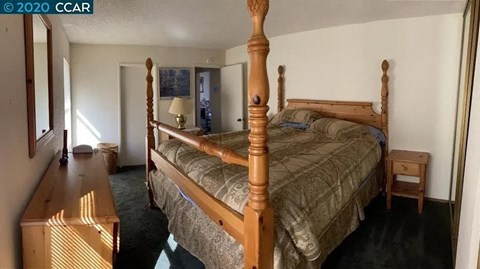 a bedroom with a large bed and a dresser