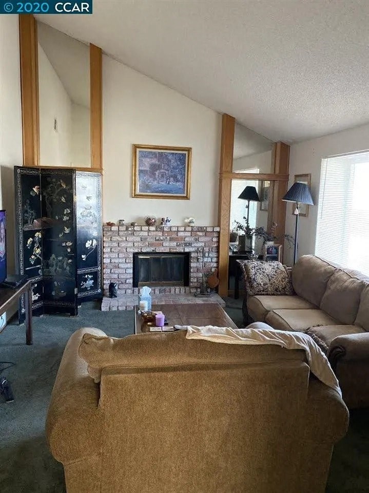 a living room with a couch and a fireplace