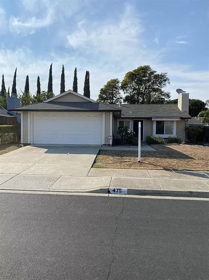 a house with a driveway and a garage door