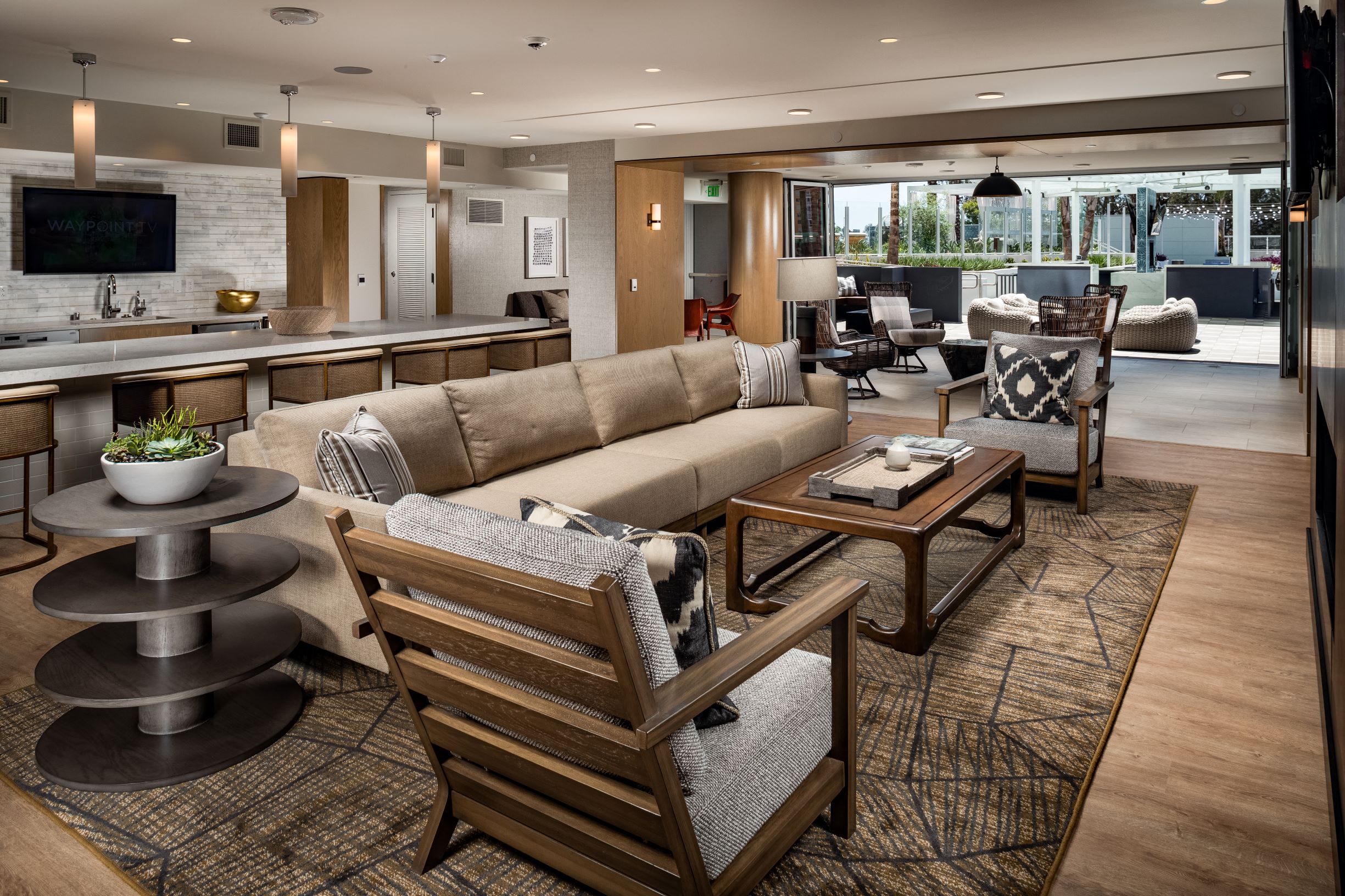A modern living room with a large couch and a television.