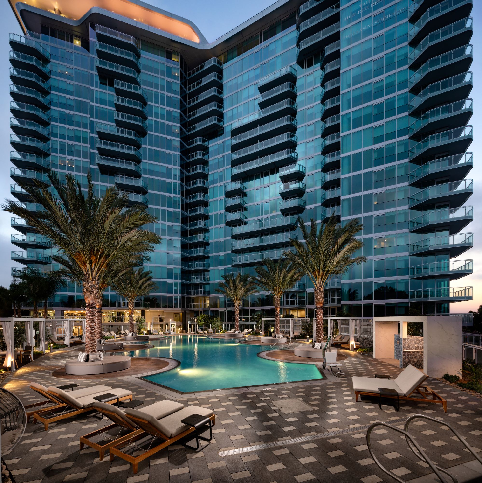 building with pool and palm trees