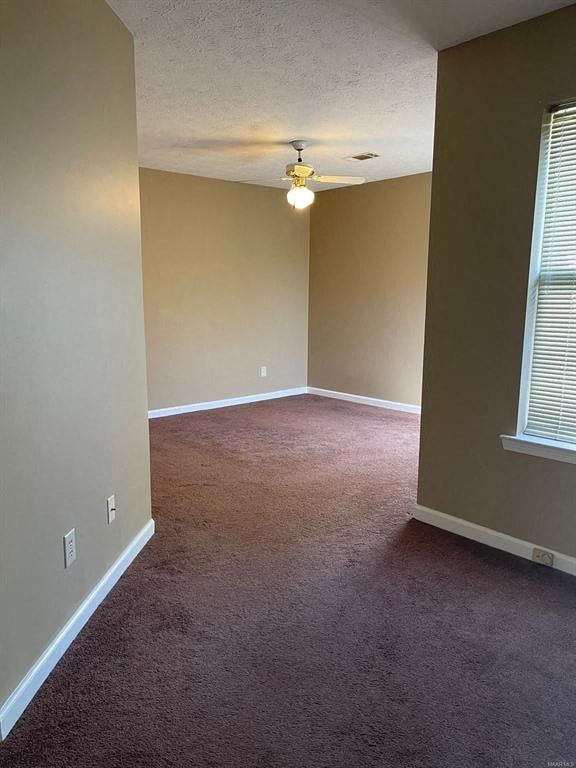 A room with a carpeted floor and a window with blinds.