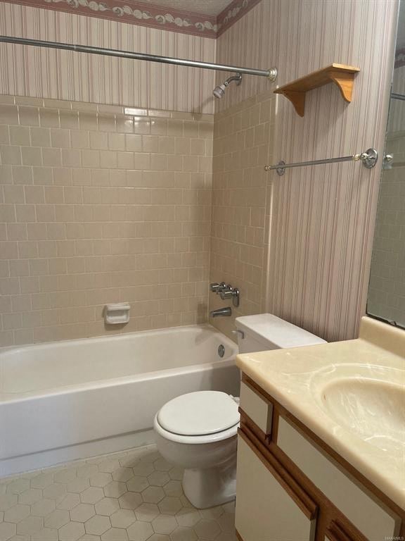 A white toilet sits in a bathroom with a white bathtub and a sink.