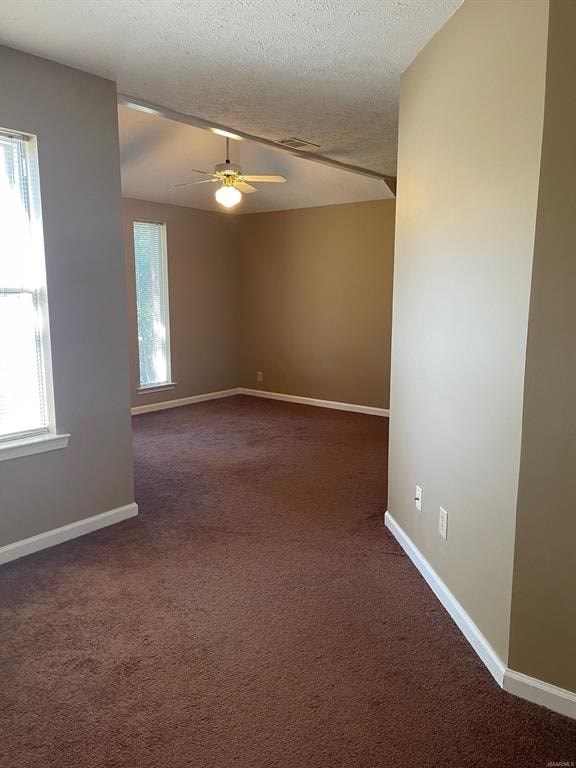 A room with a carpeted floor and a ceiling fan.