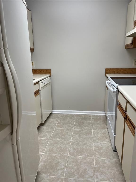 A kitchen with white appliances and white walls.
