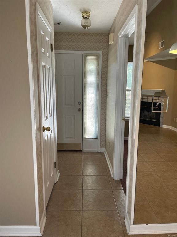 A hallway with a white door and a brown floor.