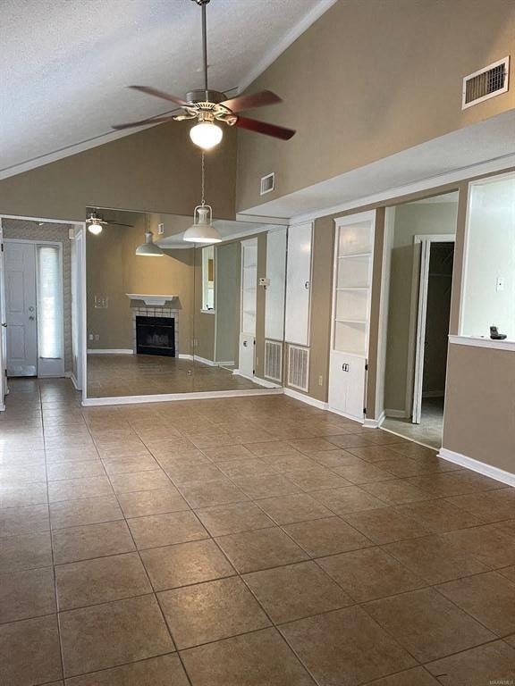 A living room with a fireplace and a ceiling fan.