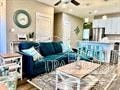 a blue couch sitting in a living room next to a table