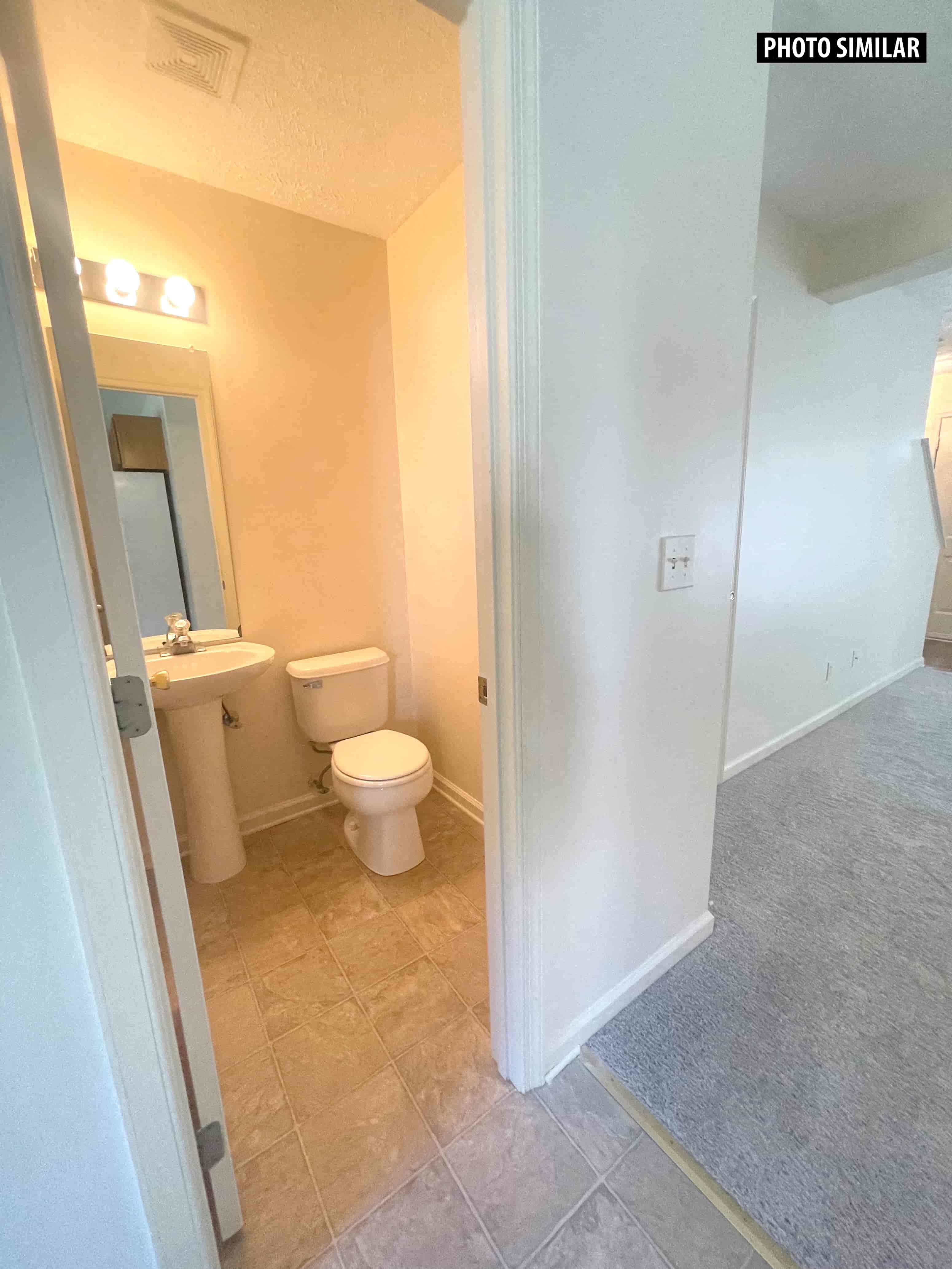 a bathroom with a toilet and a sink and a mirror