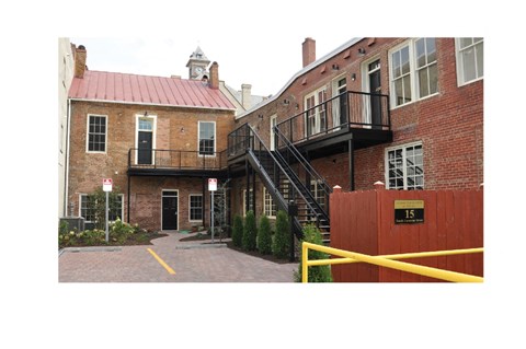 A red building with a black staircase outside.