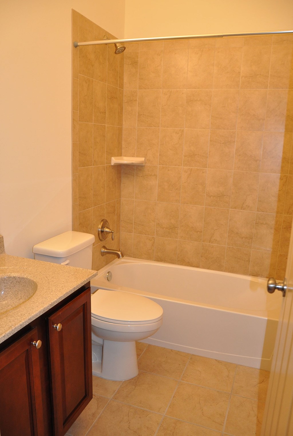 a bathroom with a toilet and a tub and a sink