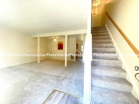 the living room and stairs to the upper level