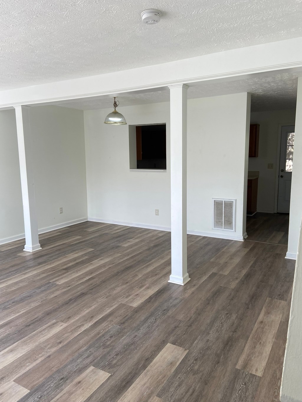 A room with wooden floors and white walls.