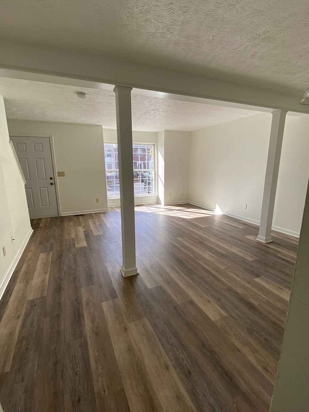 A room with wooden floors and white walls.