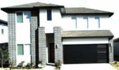 A white house with a black garage door.