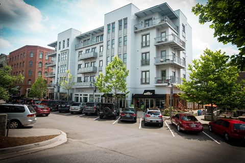 a city street with cars parked in front of a building