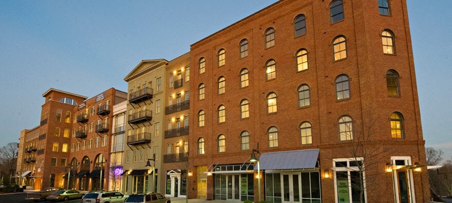 a large brick building on a city street at dusk