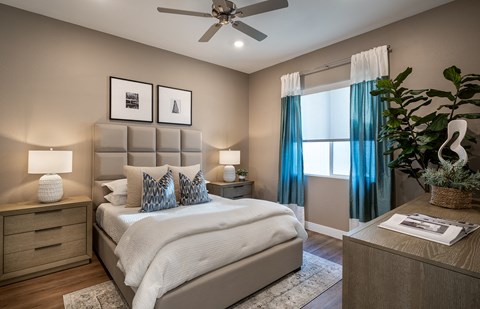 a bedroom with a bed and a ceiling fan