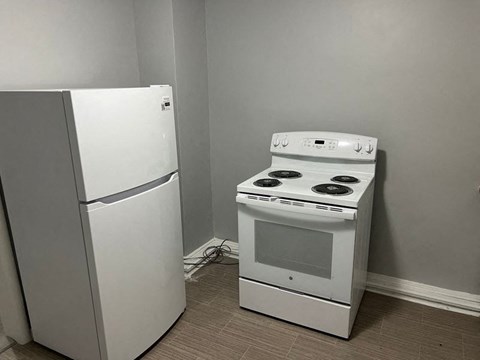 A white refrigerator and a white stove in a kitchen.