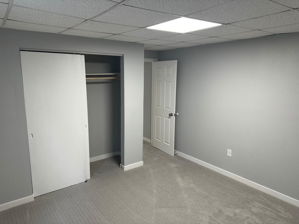 A room with a white door and a white closet door.