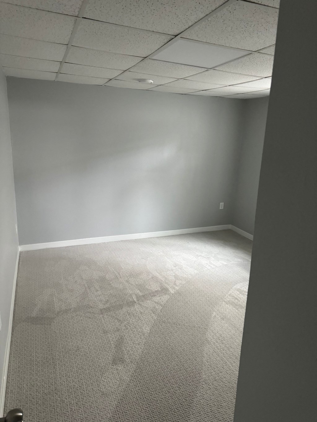 A room with a carpeted floor and a white ceiling.