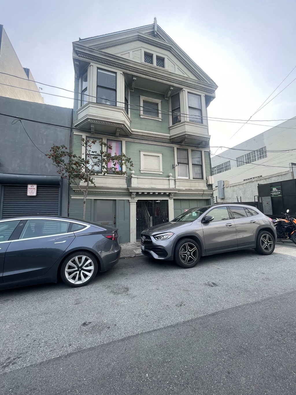 a house with two cars parked in front of it