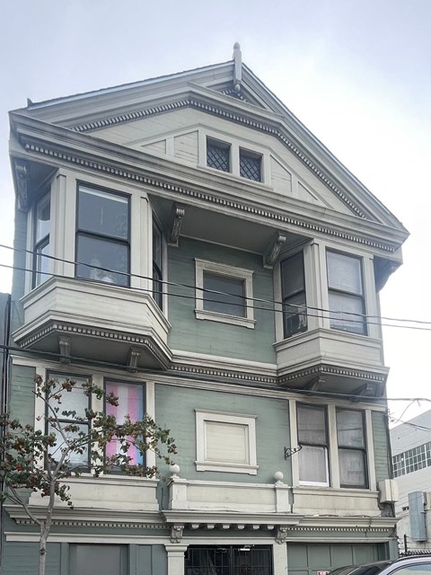 A two-story building with a balcony on the second floor.