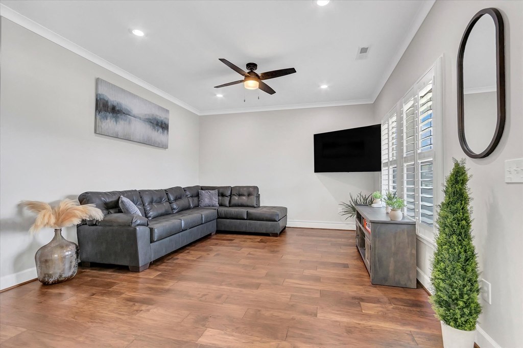 a living room with a couch and a ceiling fan
