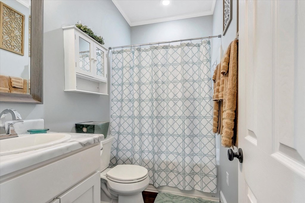 a small bathroom with a shower and a toilet and a sink