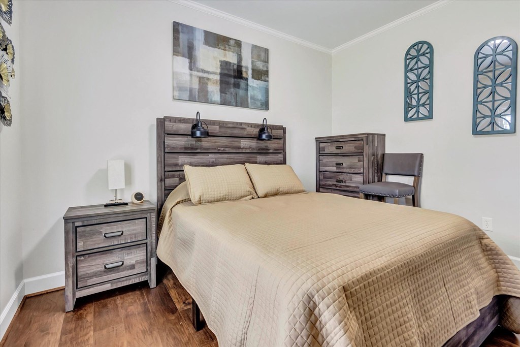 a bedroom with a bed and two wooden dressers