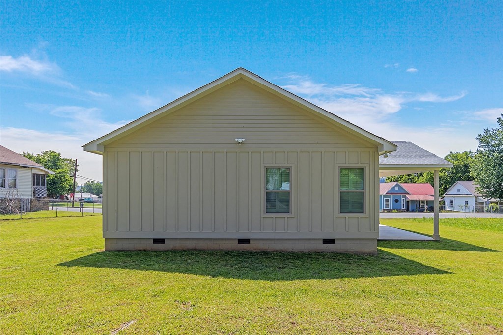 the front view of a tiny house on a grass field