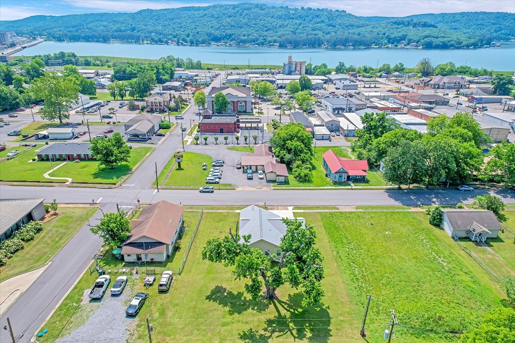 an aerial view of a neighborhood with a lake in the background