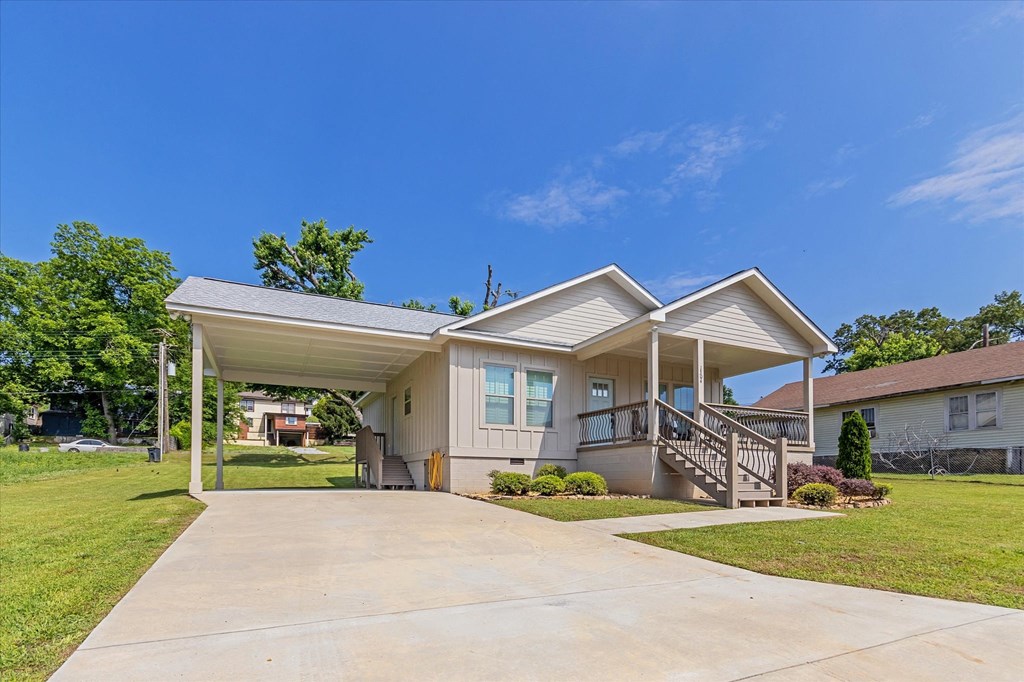 a white house with a driveway and a covered porch