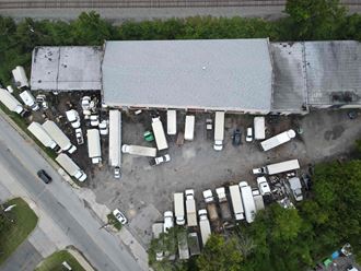 an aerial view of cars parked outside a building