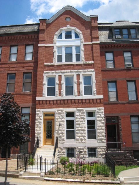 a red brick building with a large window on the front