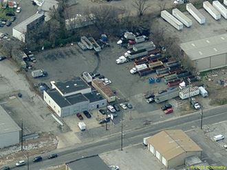 an aerial view of a parking lot with cars and trucks