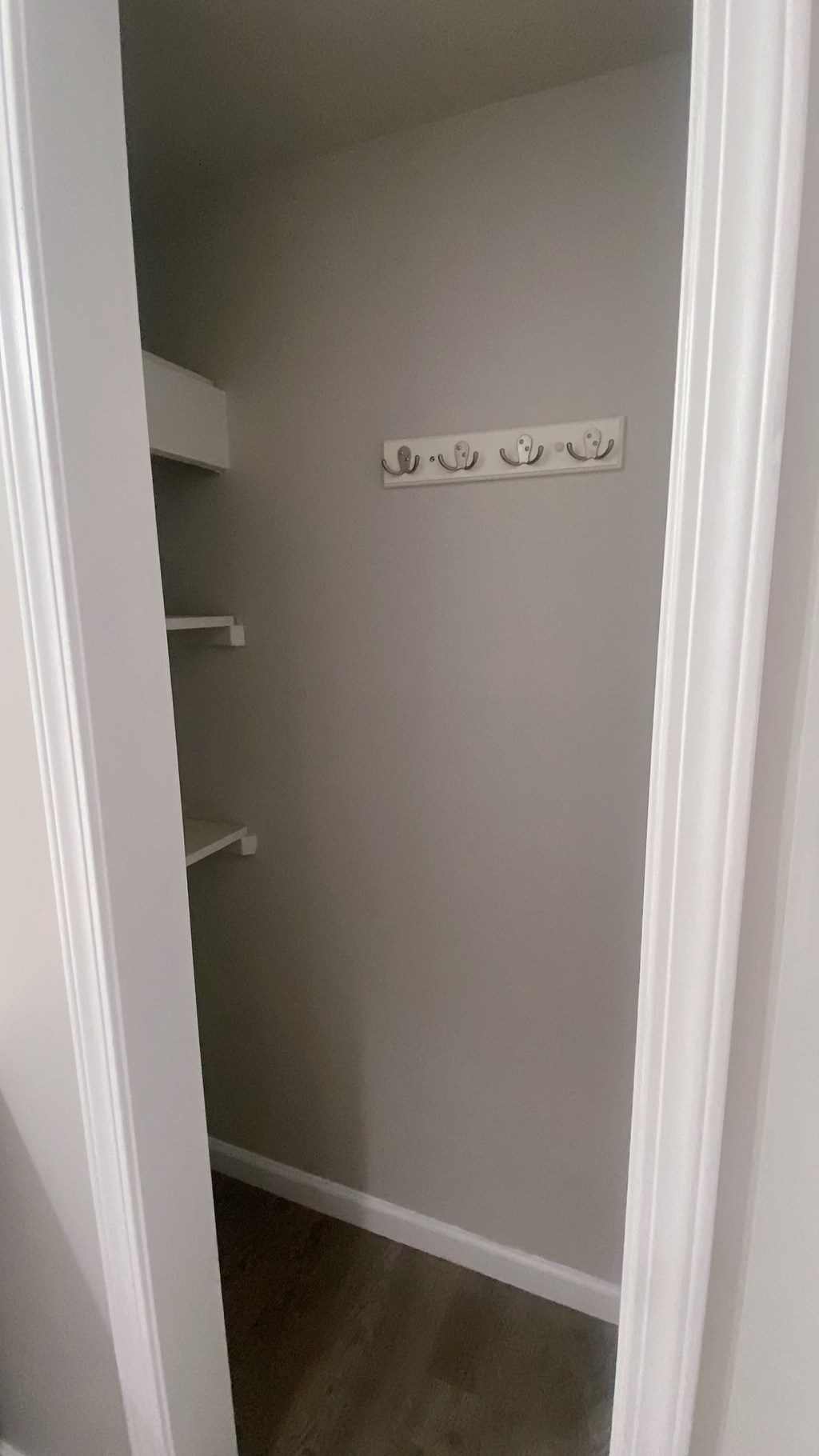 a small closet in a room with shelves