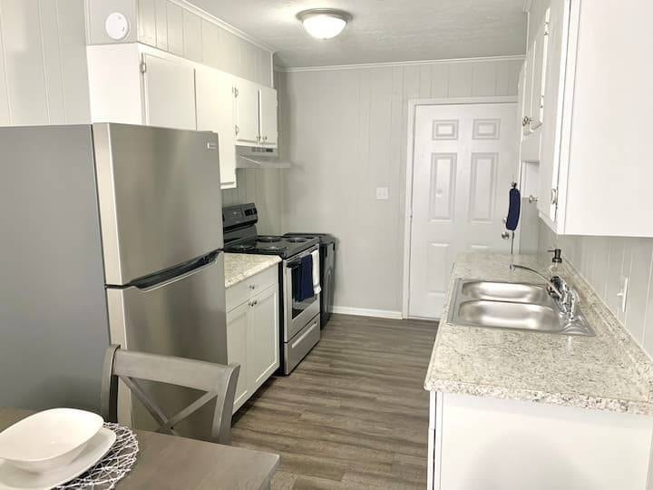 a kitchen with a stainless steel refrigerator and a sink